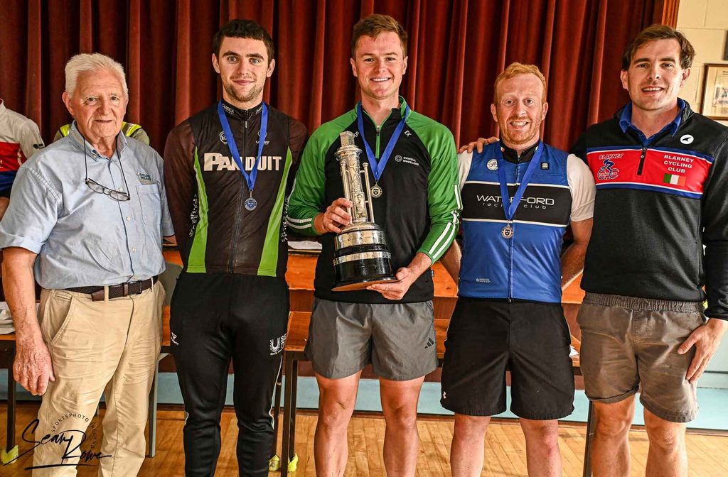 2026 Munser Road Race Podium winner Evan Keane, Pinergy Orwell Wheelers, Patrick O'Loughlin, Panduit Carrick Wheelers Silver, James Griffin, Waterford Racing Club Bronze with Mick Twomey and Blarney Cycling official.
